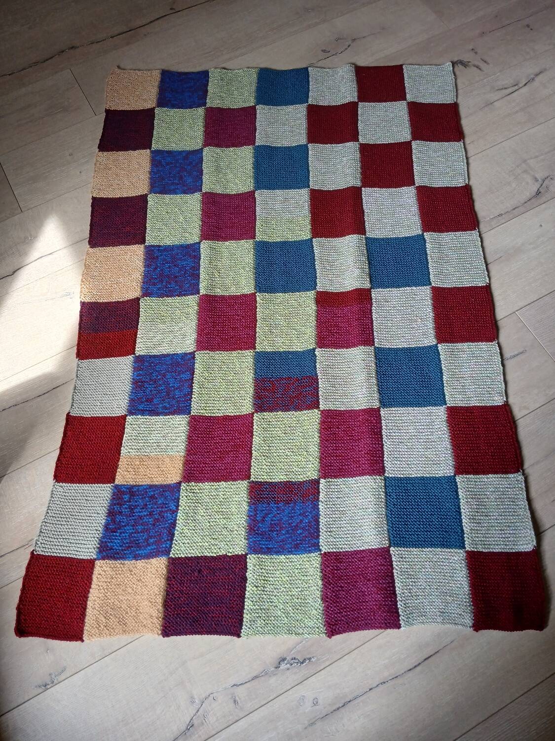 Hand knitted patchwork plaid