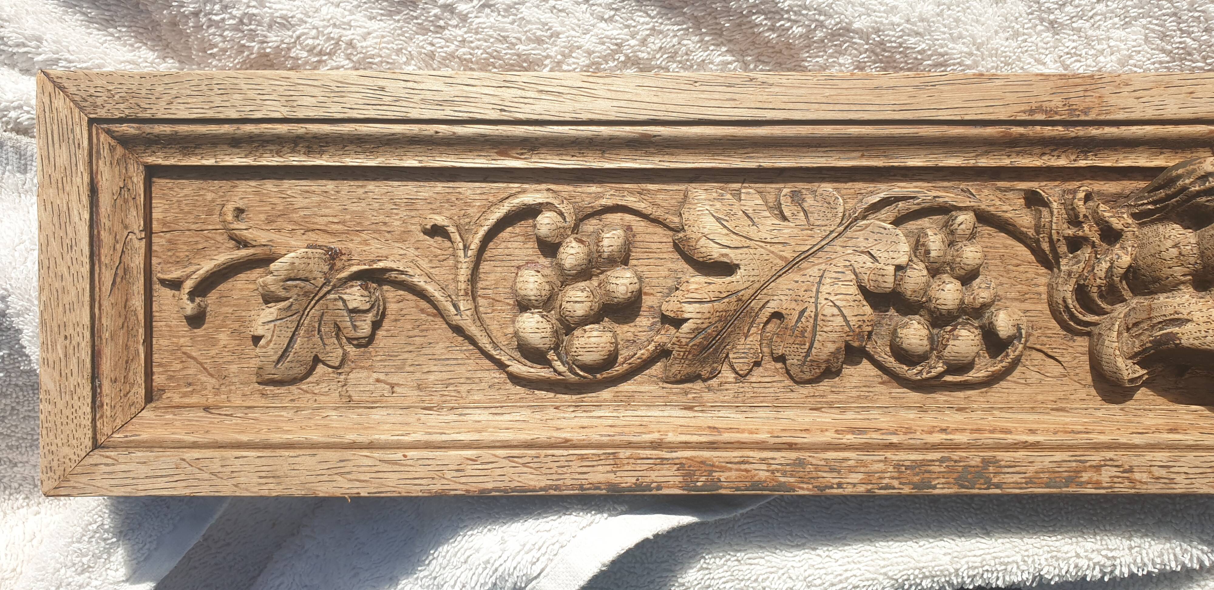 Carved wooden pediment with bunches of grapes