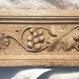 Carved wooden pediment with bunches of grapes
