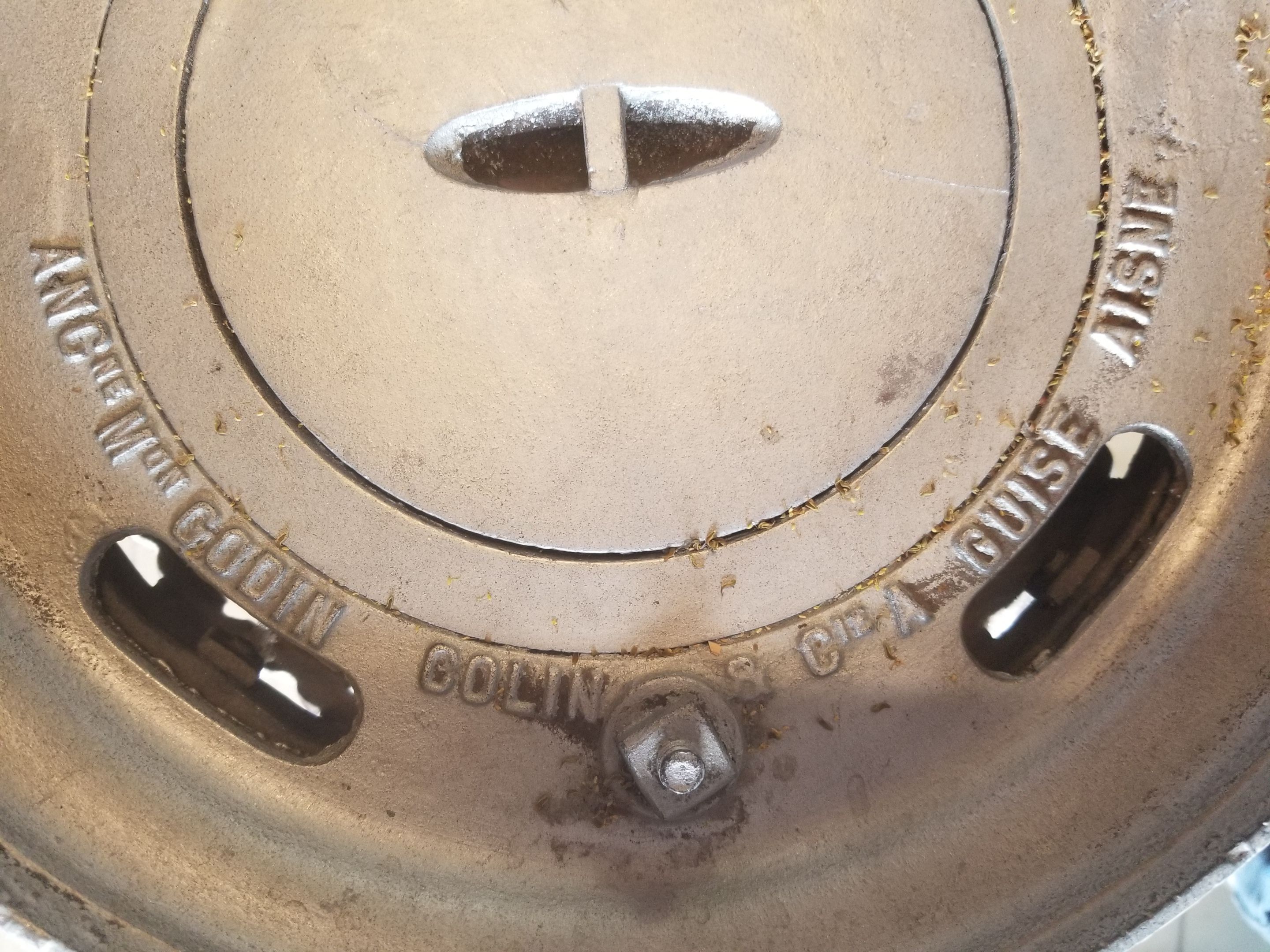 Old compact wood stove in enamelled cast iron with tripod feet with Lion's legs