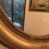 Oval mirror in gilded wood late 19th