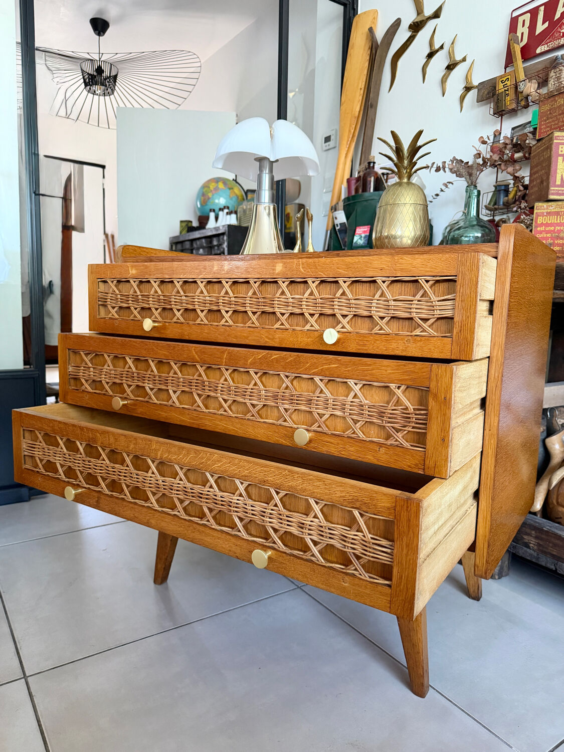 Vintage wooden and rattan chest of drawers with tapered legs.