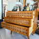 Vintage wooden and rattan chest of drawers with tapered legs.