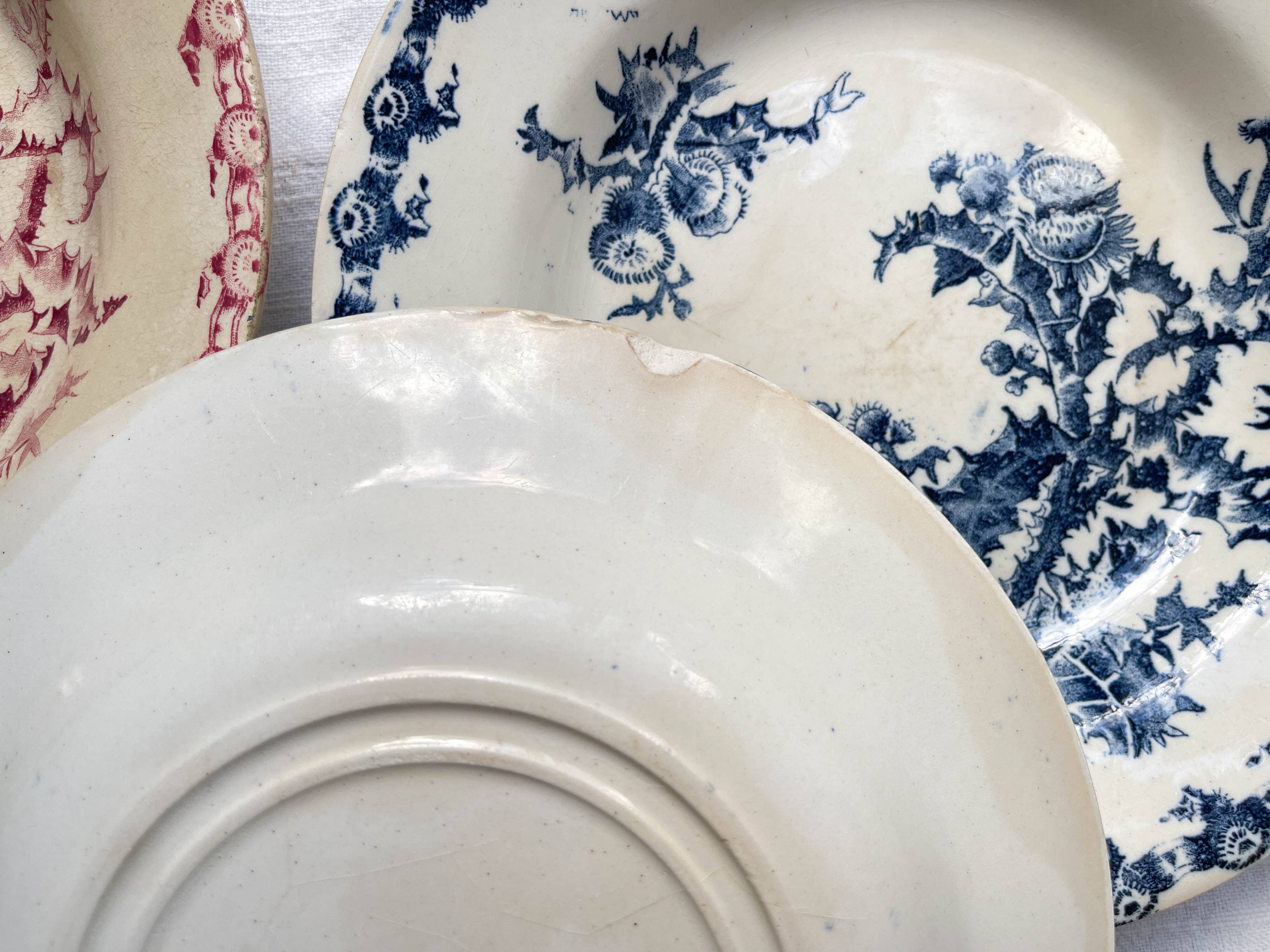 10 mismatched vintage soup plates in blue, green, and red ironstone