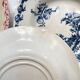 10 mismatched vintage soup plates in blue, green, and red ironstone
