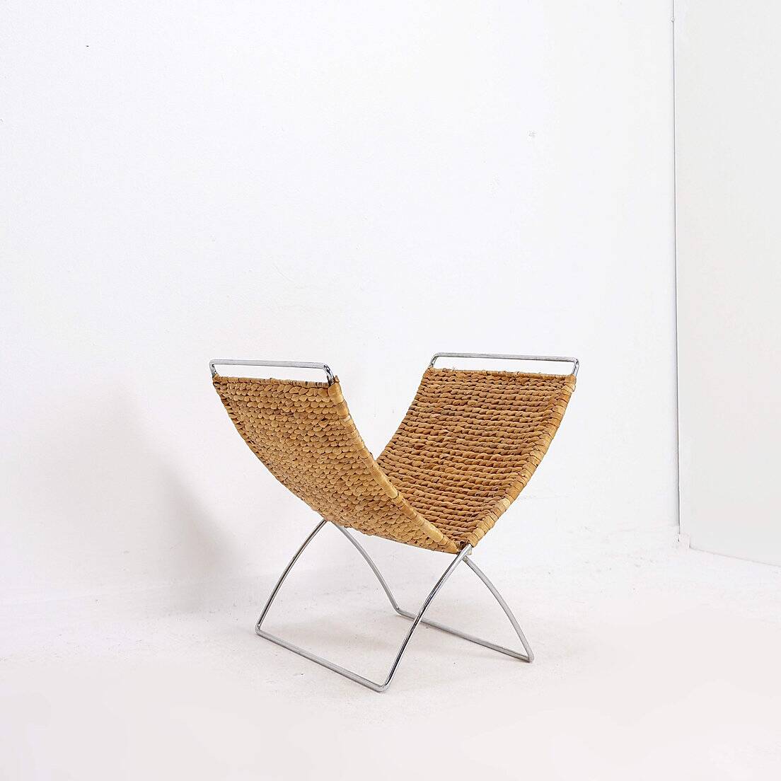Chrome metal magazine rack with woven banana leaves