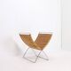 Chrome metal magazine rack with woven banana leaves