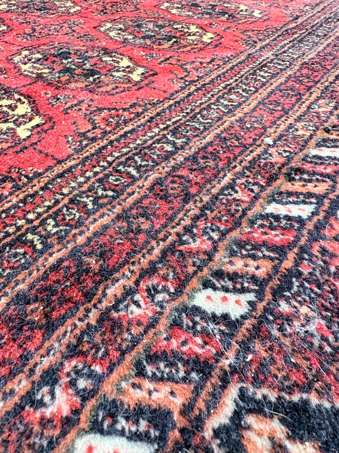 Large red Bokhara-style oriental carpet 300x200 cm with gul patterns.