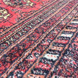 Large red Bokhara-style oriental carpet 300x200 cm with gul patterns.