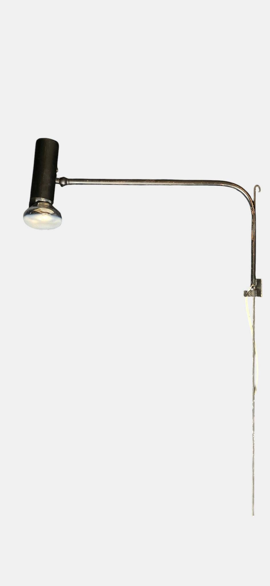 Minimalist metal wall light in the style of Jean Prouvé, circa 1950.