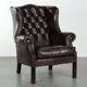 Dark brown cowhide Chesterfield wingback armchair in classic English style