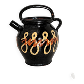 Old vase in glossy black ceramic, vintage exterior decoration.