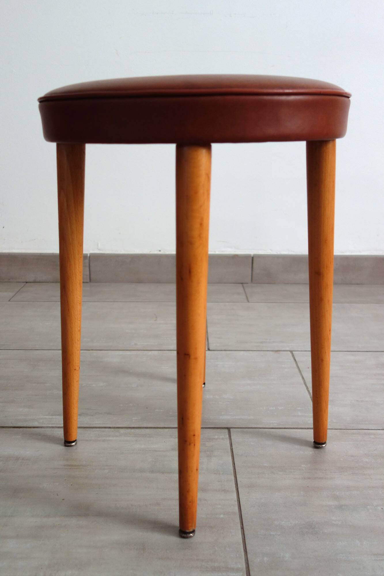 Baumann low stool from the 60s in brown leatherette