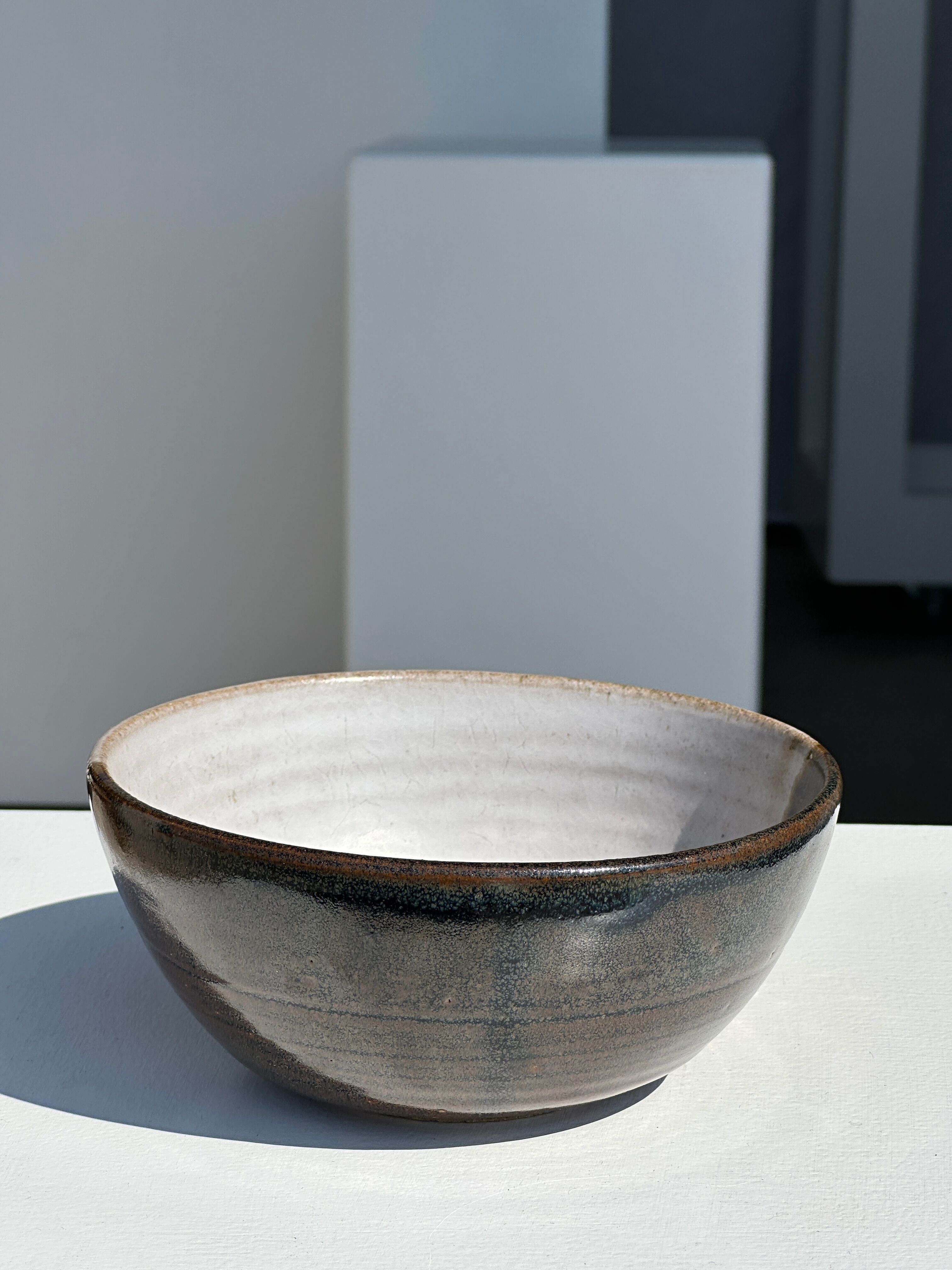 White and glossy brown two-tone ceramic bowl, matt earth