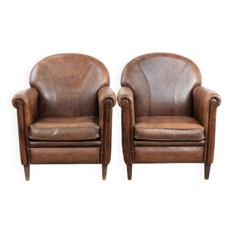 Set of 2 vintage sheepskin armchairs with a characterful appearance