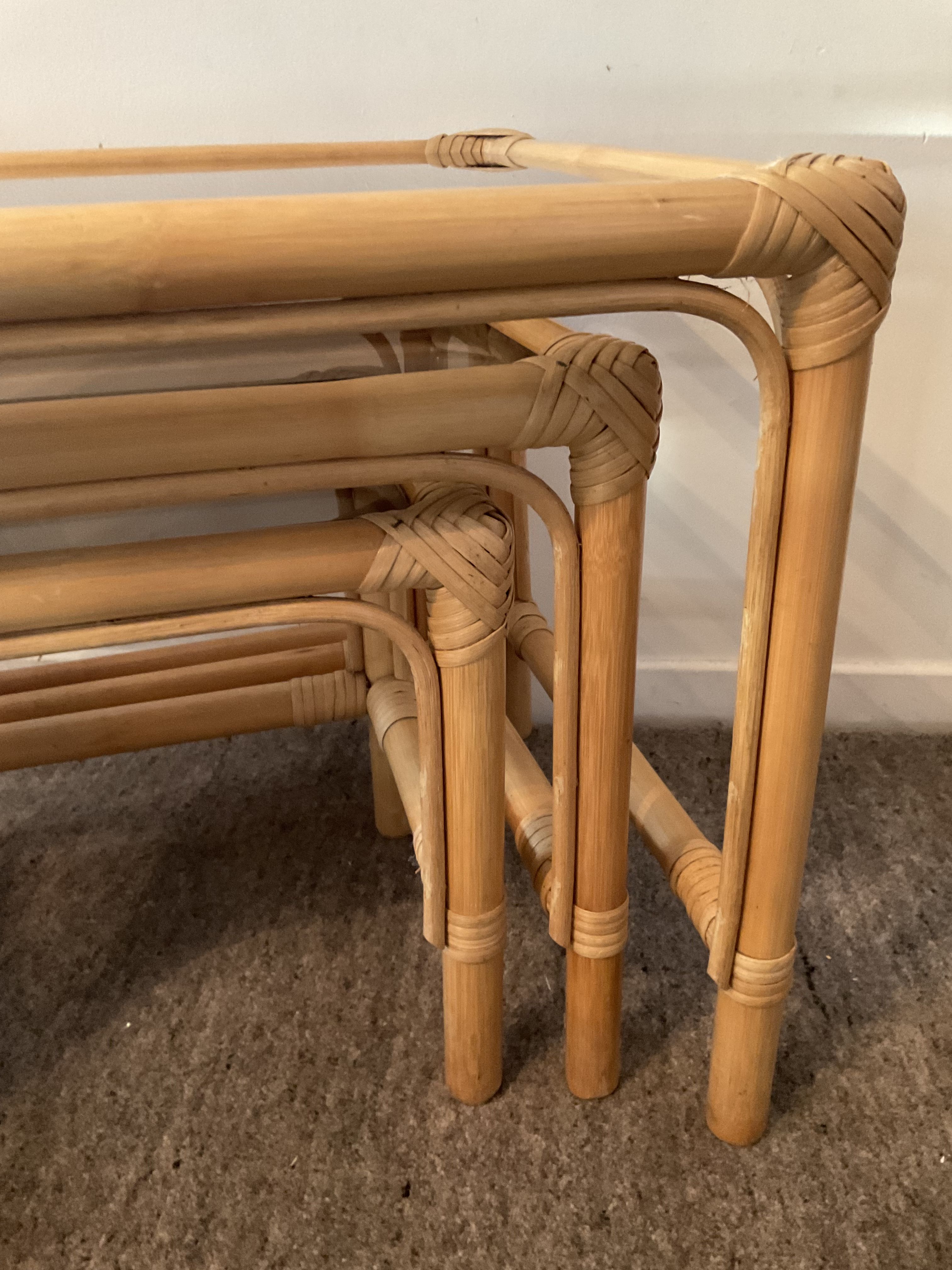 Trio of vintage pull-out tables in rattan and smoked glass 70s
