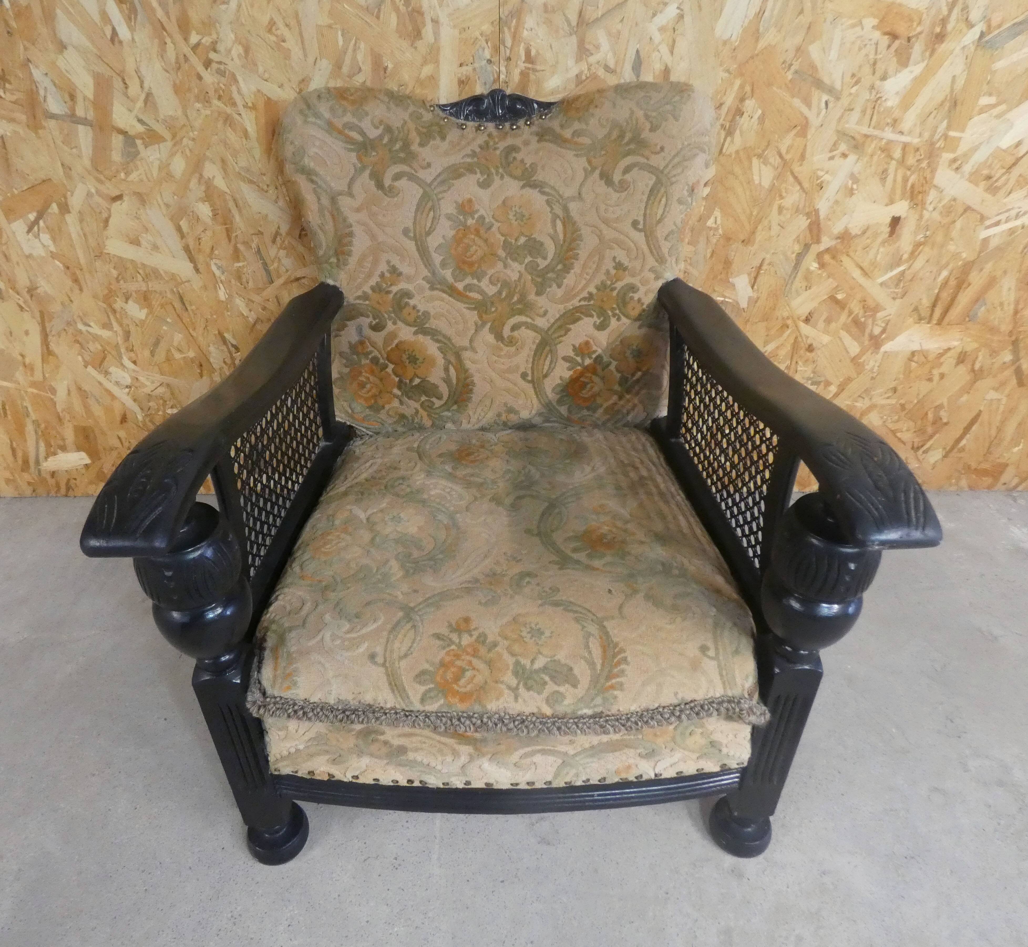 Old armchair upholstered in velvet, carved and caned wood