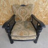 Old armchair upholstered in velvet, carved and caned wood