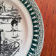 Old vintage dessert plate with drawing and phrase "swimming"