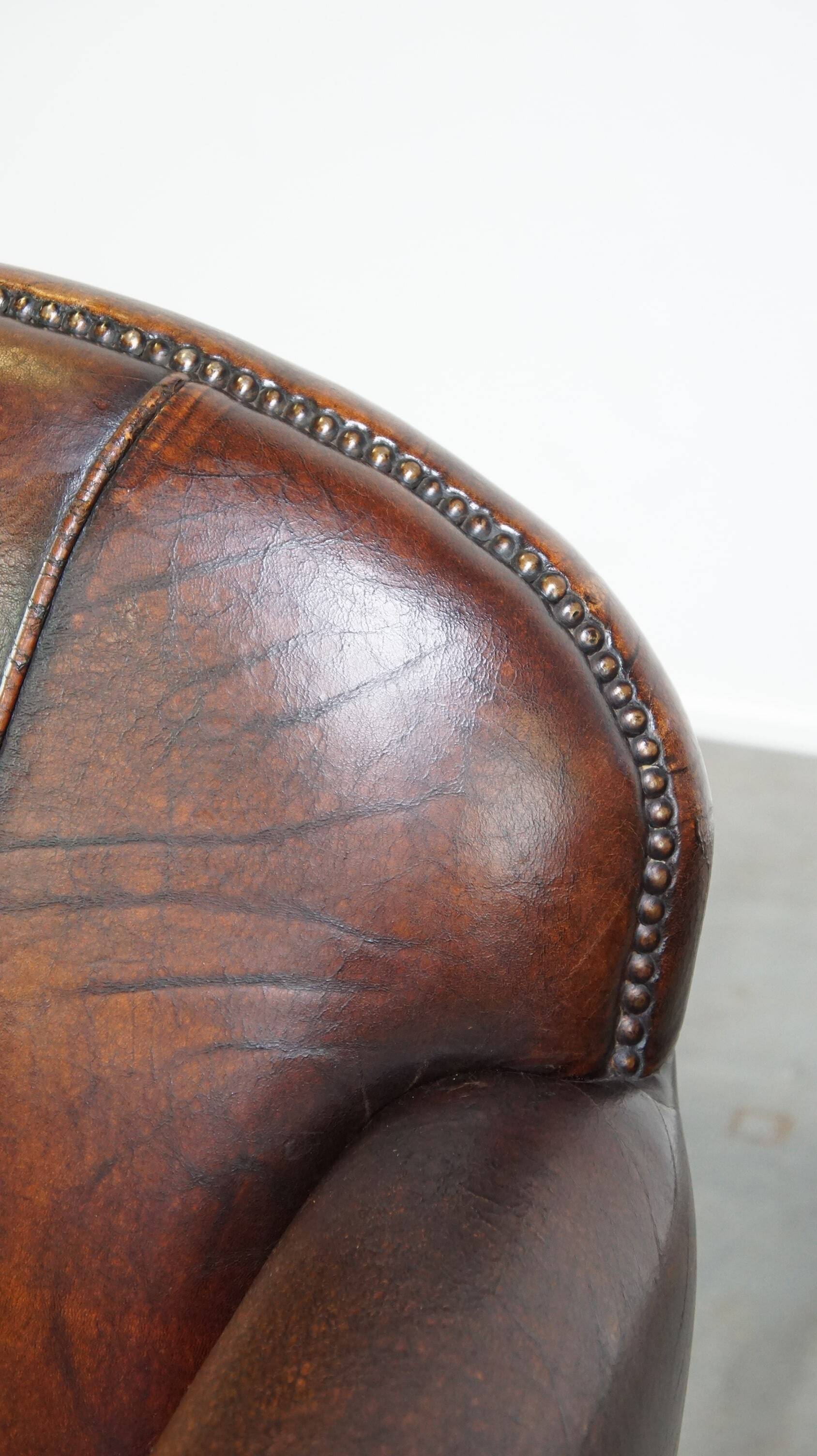 A vintage-style armchair with character, upholstered in beautifully patinated sheepskin.