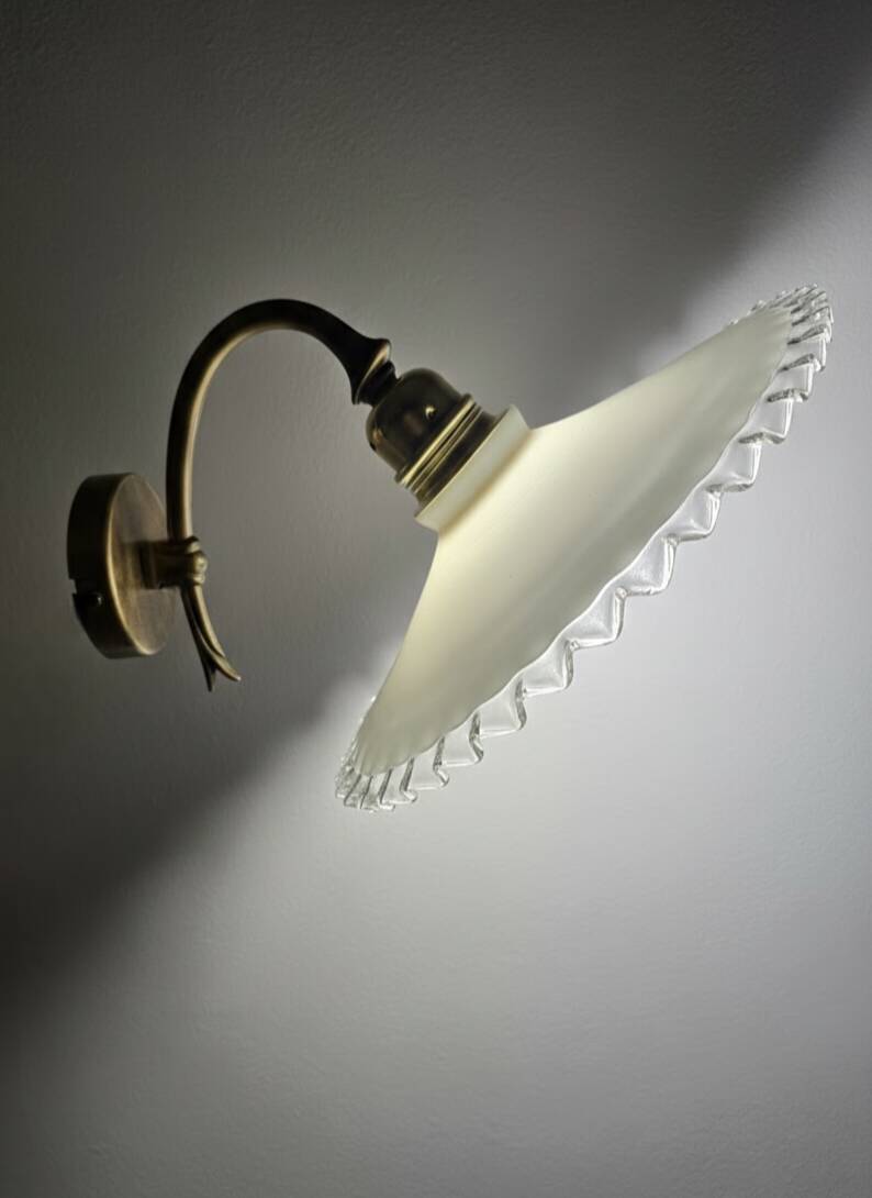 Wall sconces with scalloped opaline lampshades.