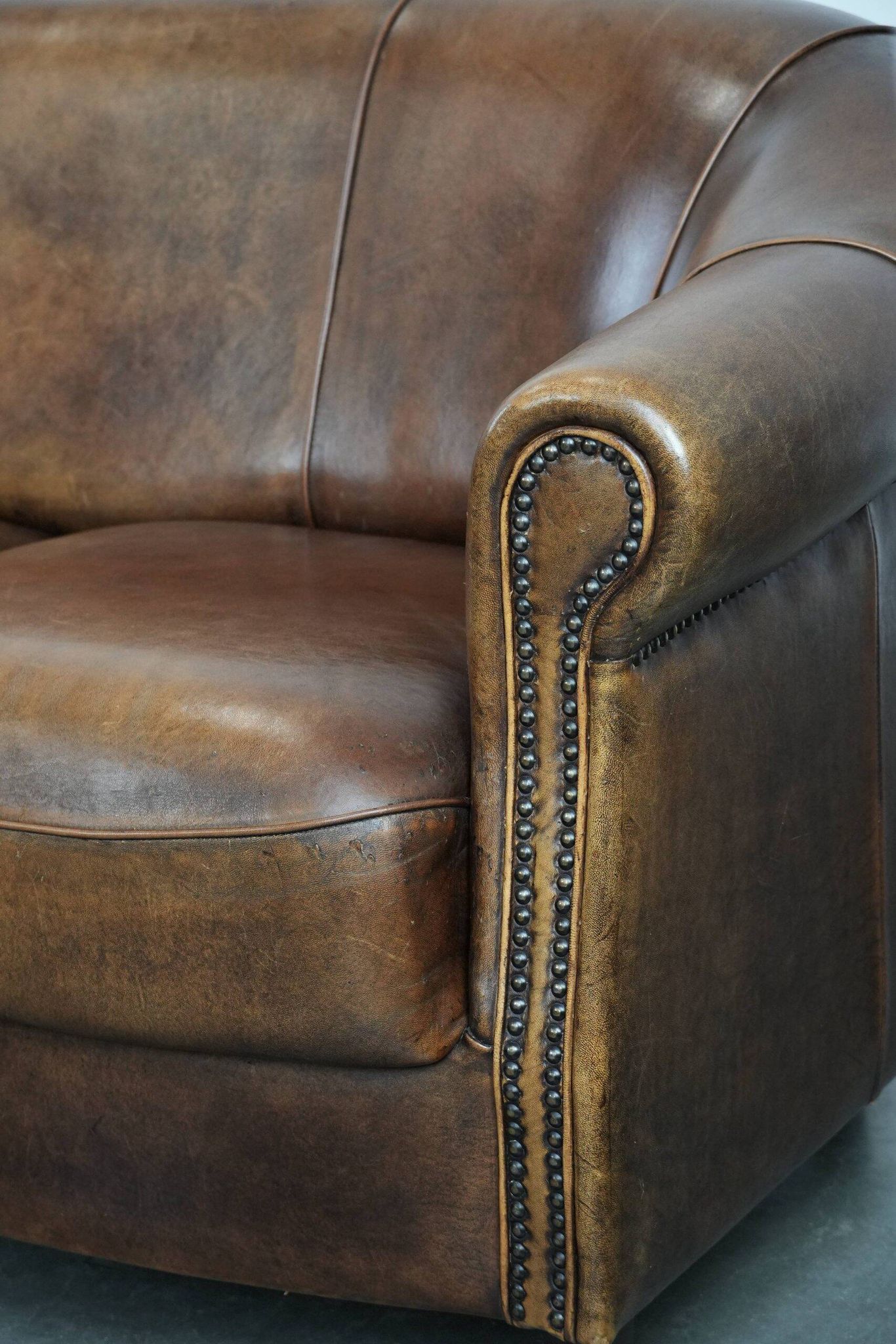 Characterful vintage sturdy 2-seater club sofa made of sheepskin leather