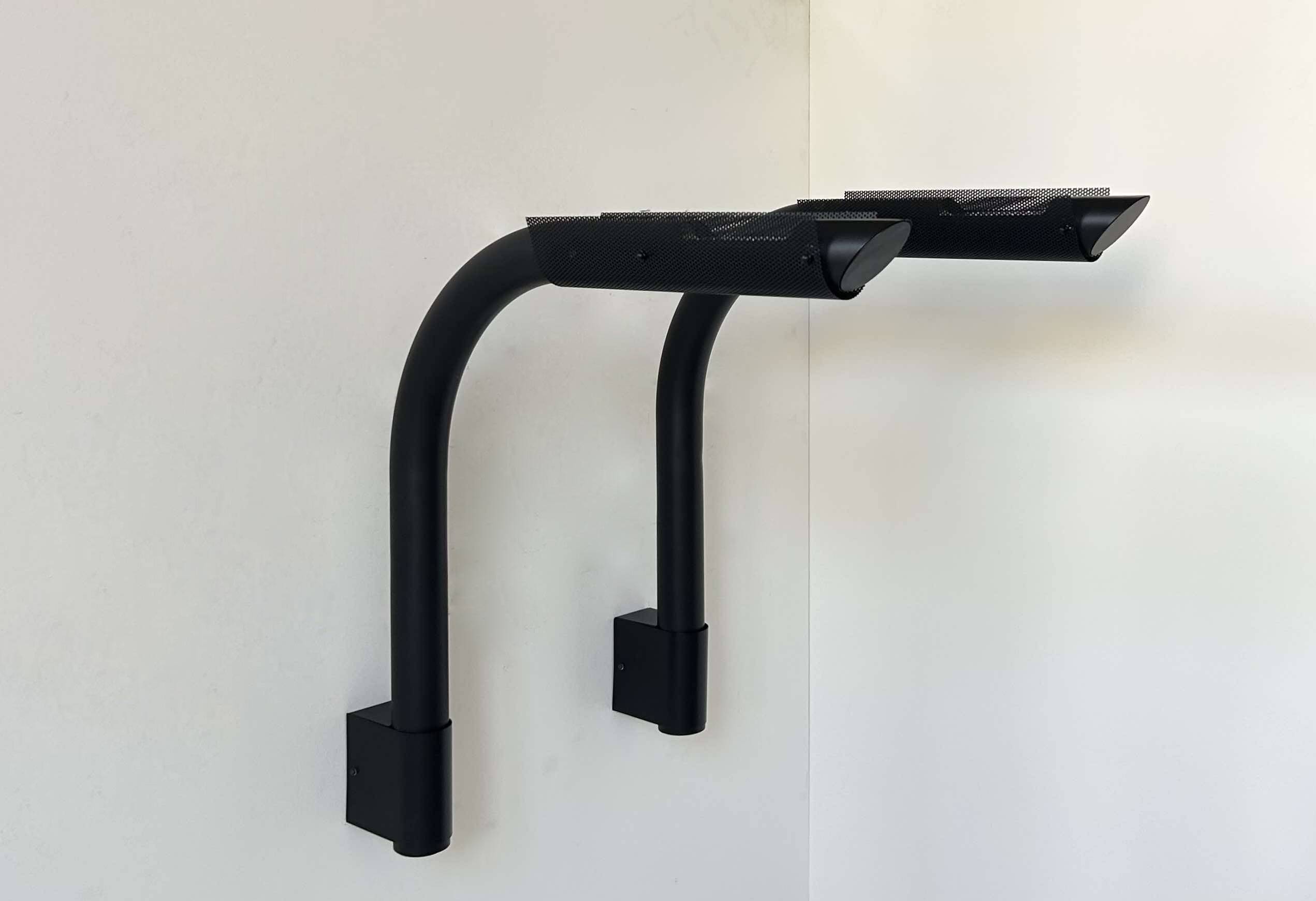 Pair of vintage wall lights, tubular and perforated black metal, Parscot France 1980