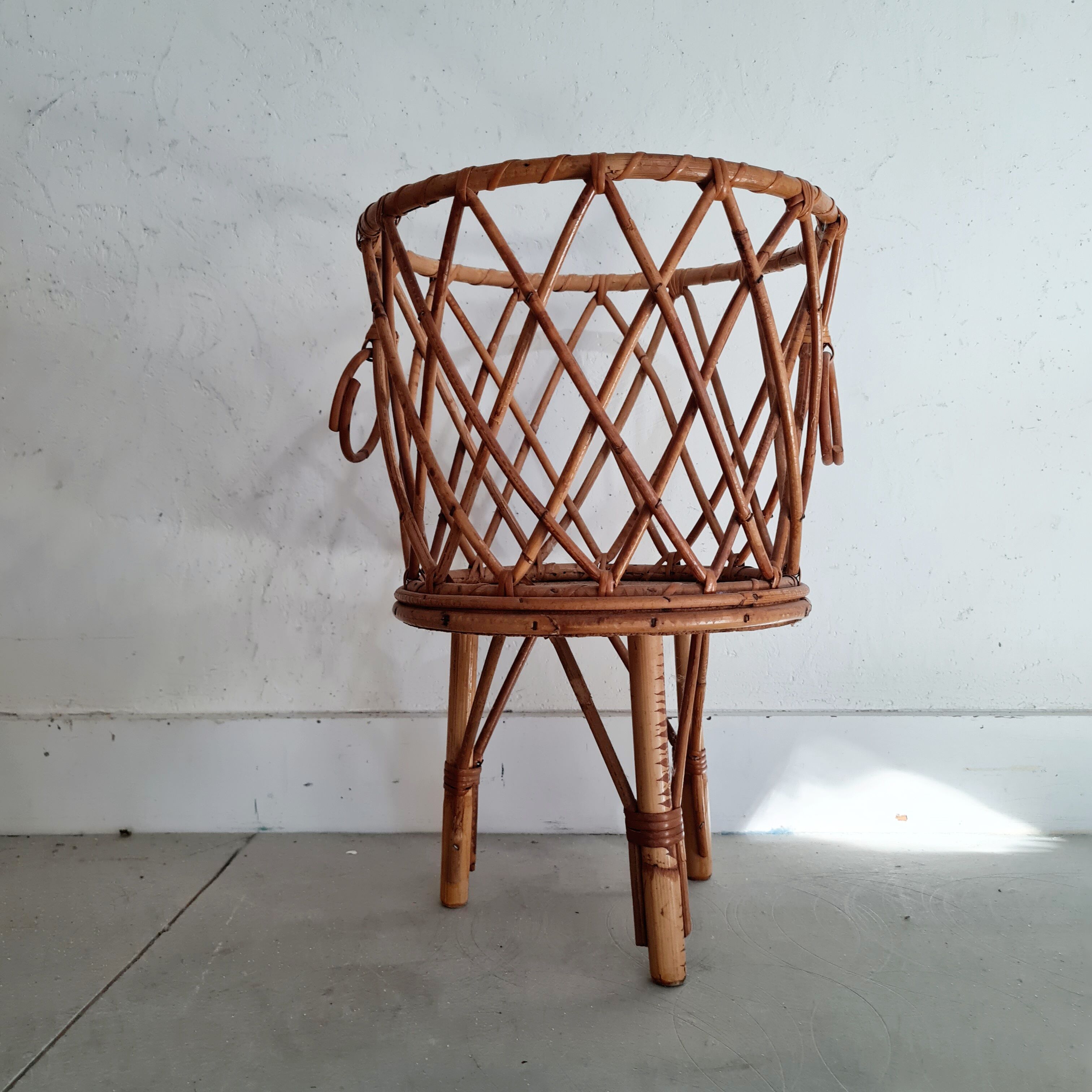 Old tripod rattan plant holder