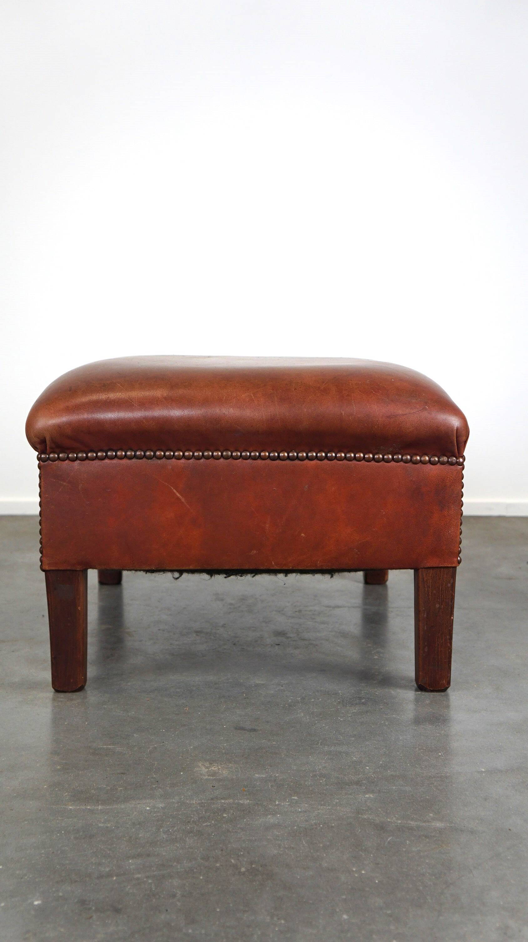 Leather ottoman in classic English style finished with decorative nails