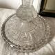 Tall molded glass candle holder with ram heads