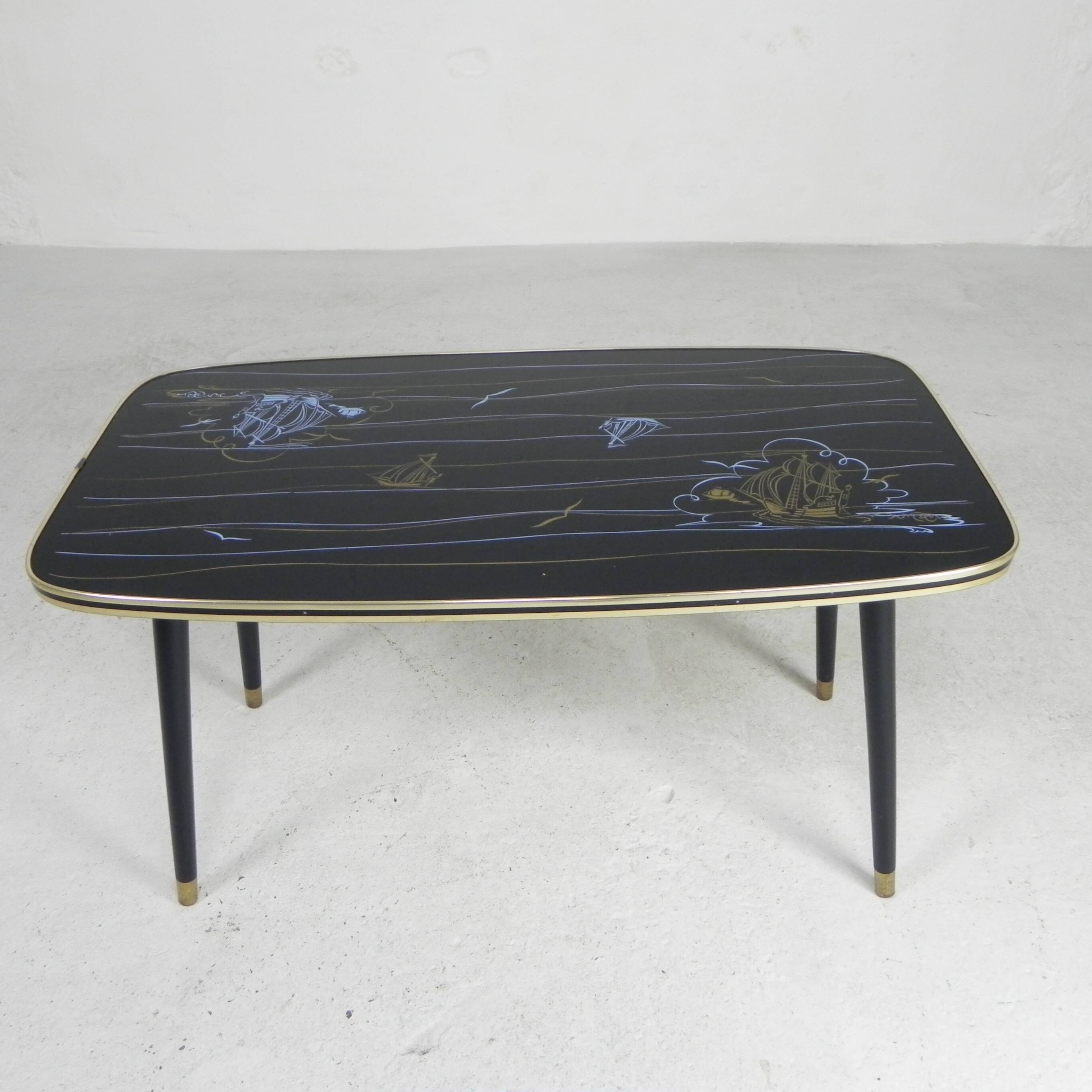 Vintage coffee table with glass top and angled legs