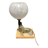 Lamp representing a seal on a marble base
