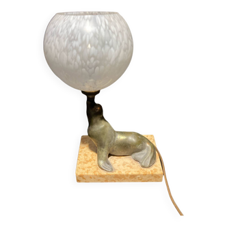 Lamp representing a seal on a marble base