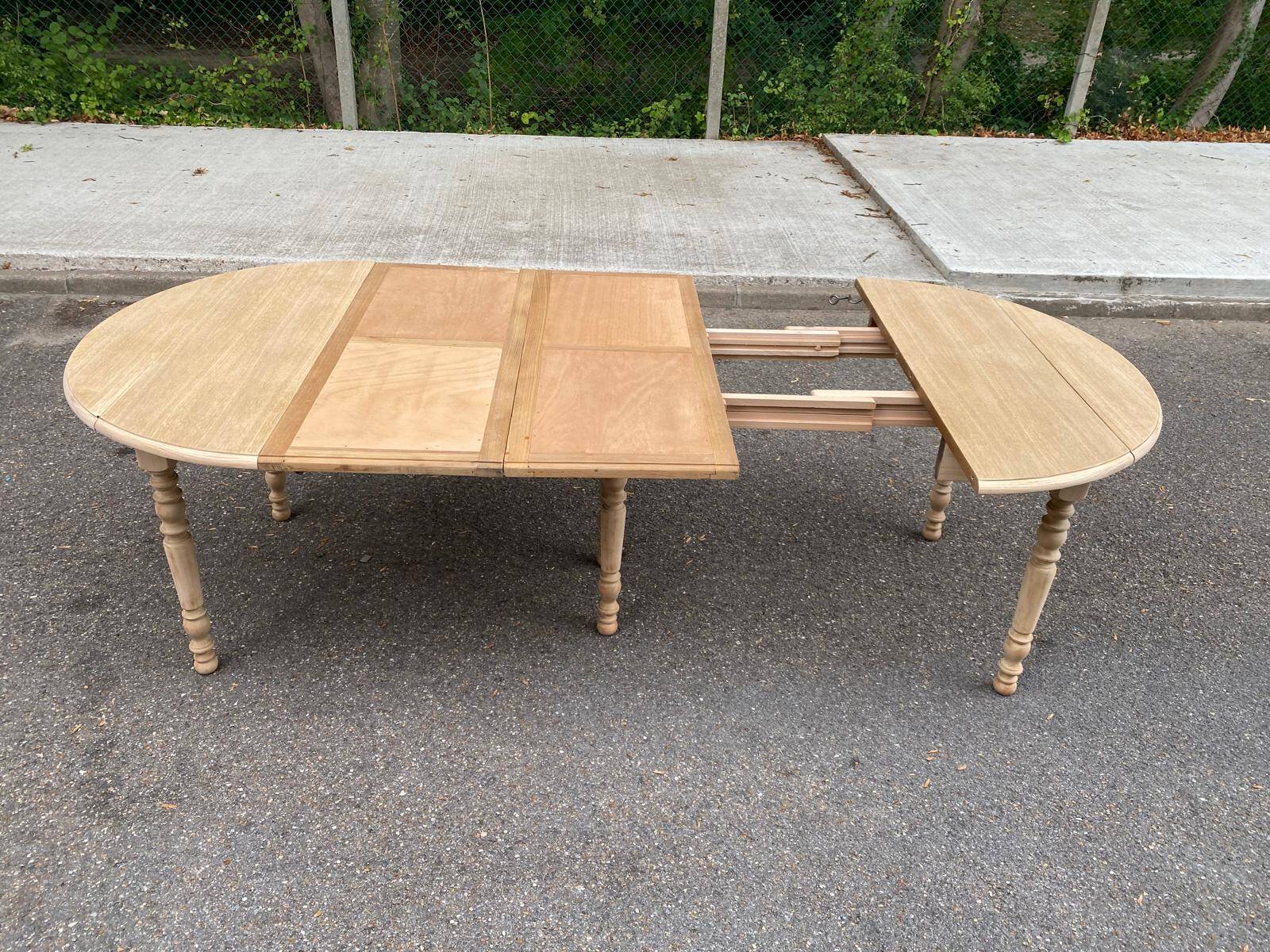 Round dining table with extendable leaves, Louis Philippe style, stripped in raw oak.