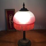 Old table/bedside lamp with glass shade with pink gradients and fringes.