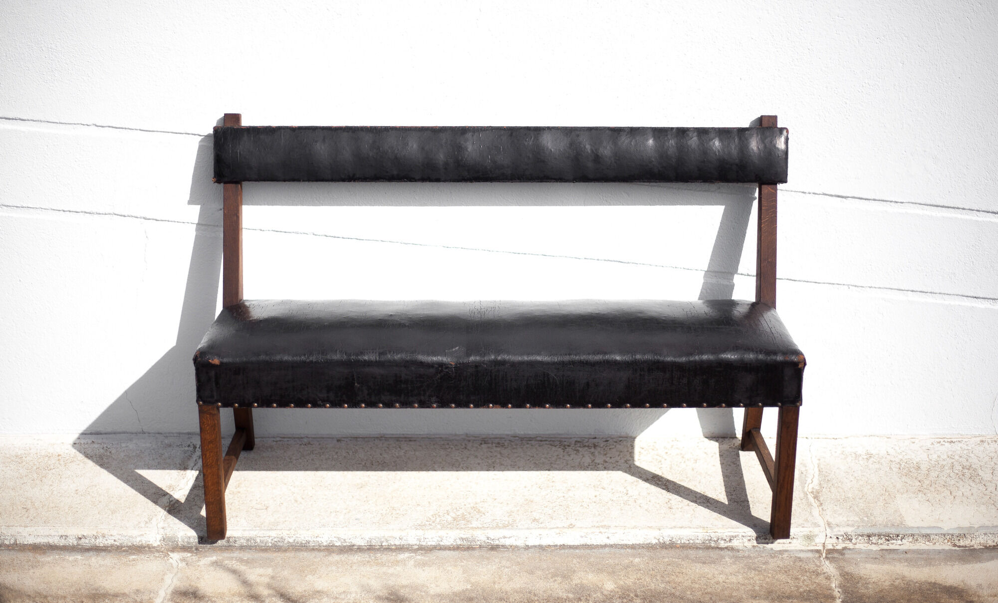 Antique wood bench and black imitation leather