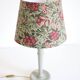 Table lamp, turned wooden base and antique printed lampshade