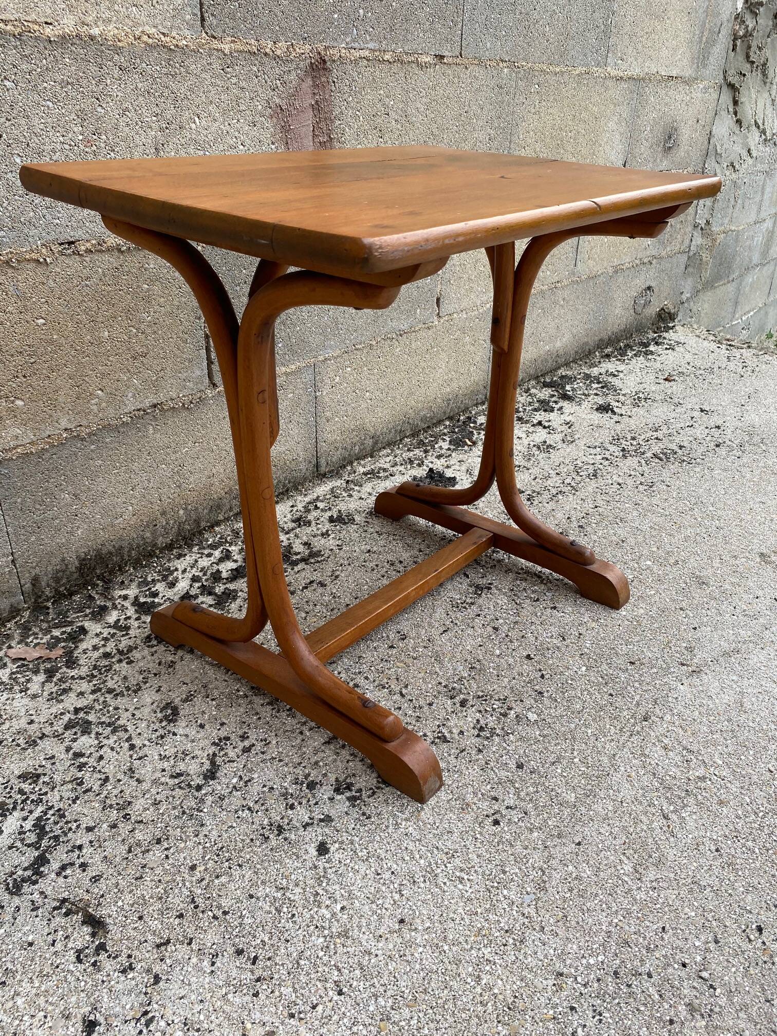 Small side table or bistro serving table with curved wood.