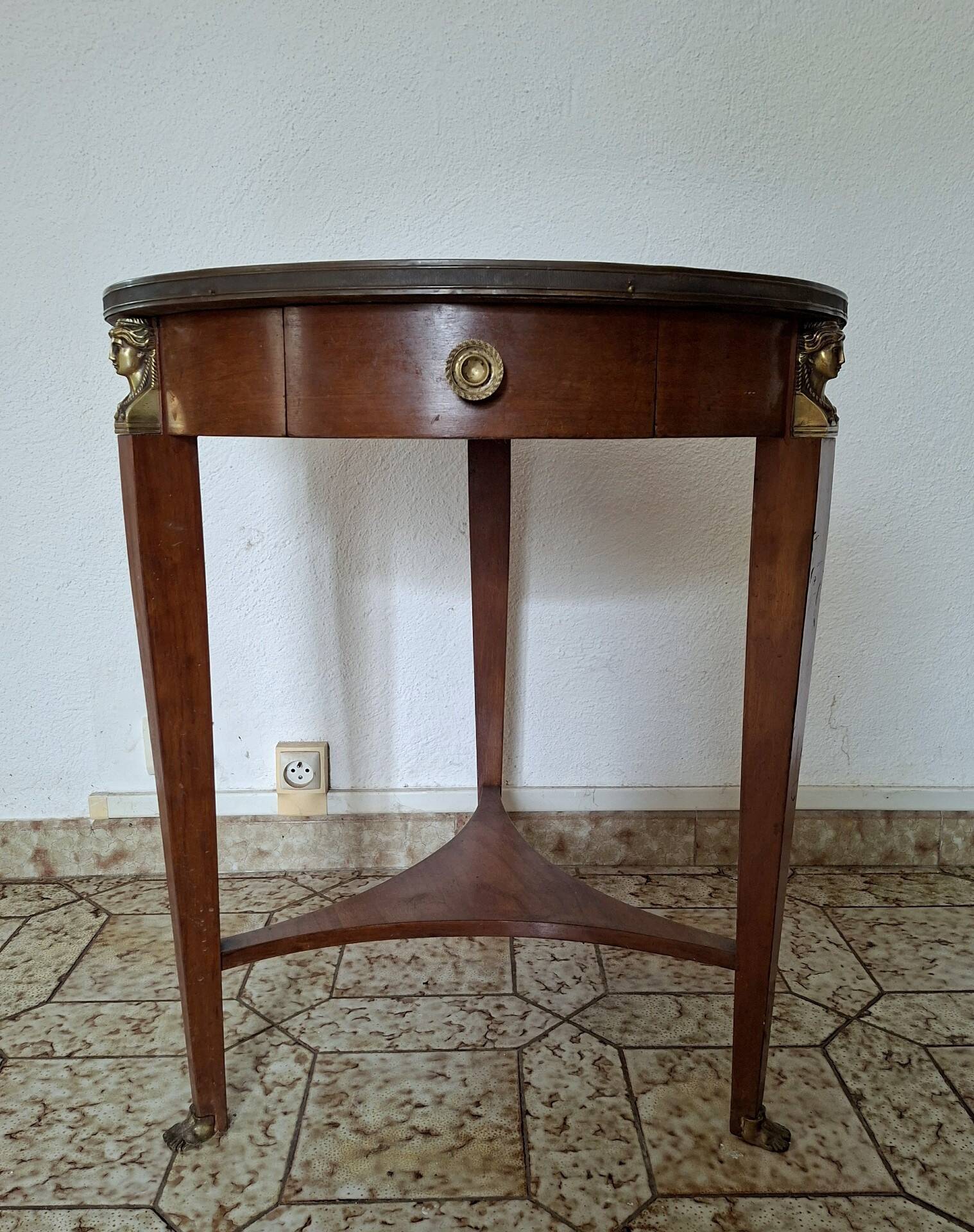 Empire guéridon table in mahogany with a black marble top and gilded bronze.