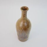 Brown ceramic/stoneware bottle with chiseled floral pattern