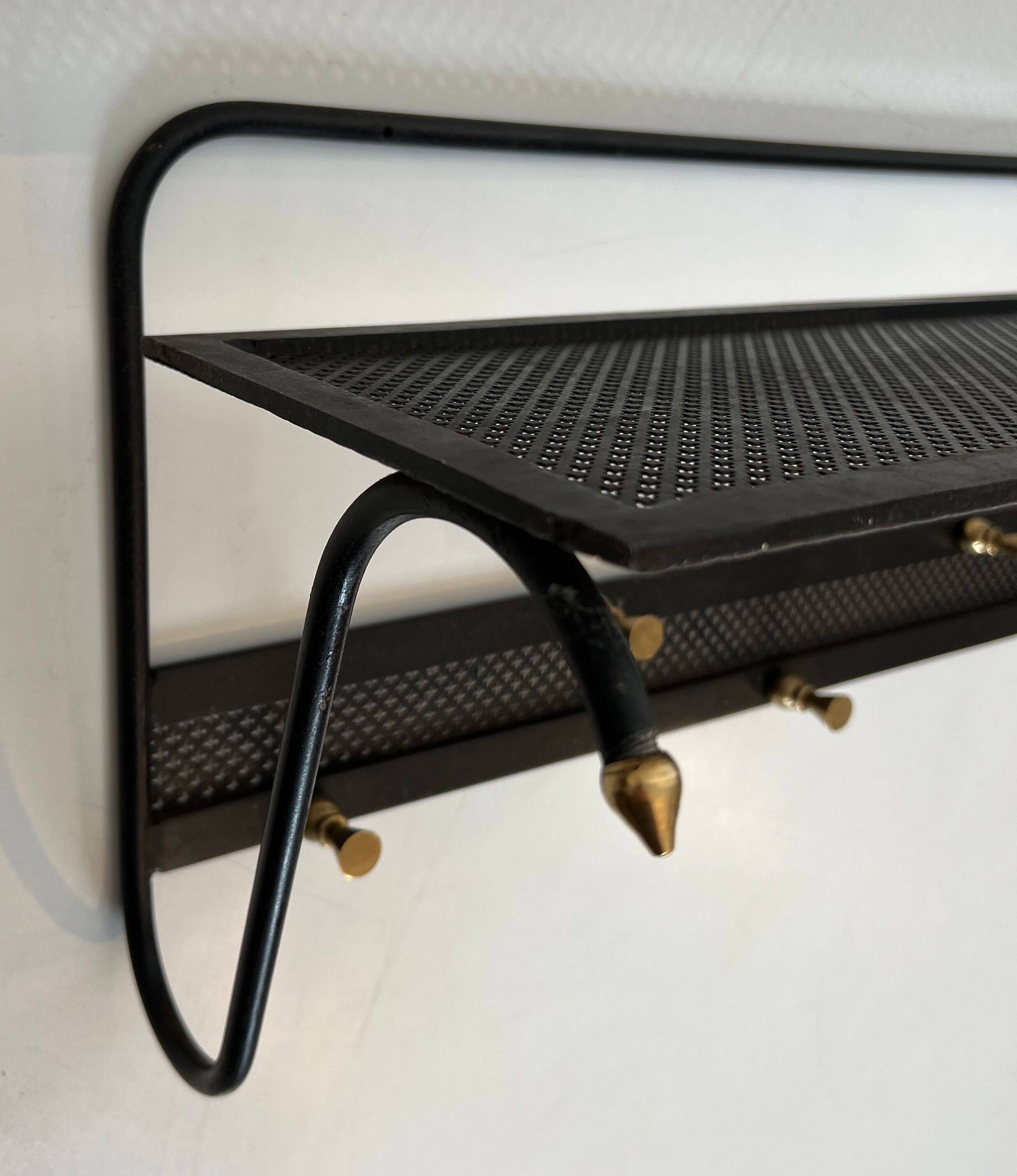 Coat rack in black lacquered metal, perforated sheet metal and brass in the style of Mathieu Matégot