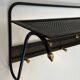 Coat rack in black lacquered metal, perforated sheet metal and brass in the style of Mathieu Matégot