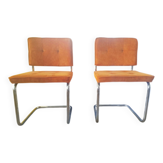 Pair of vintage cantilever chairs in chrome and orange corduroy.