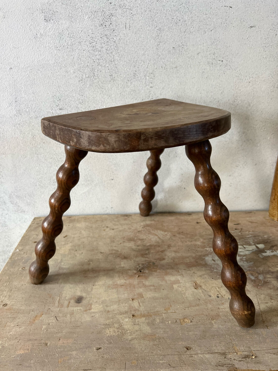 Wooden tripod farm stool