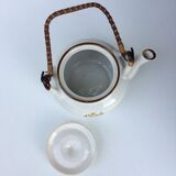 Vintage teapot with wicker handle