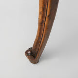 Side table with sculpted elements and rattan top