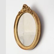 Oval giltwood mirror with rococo-style floral crest, mid-20th century