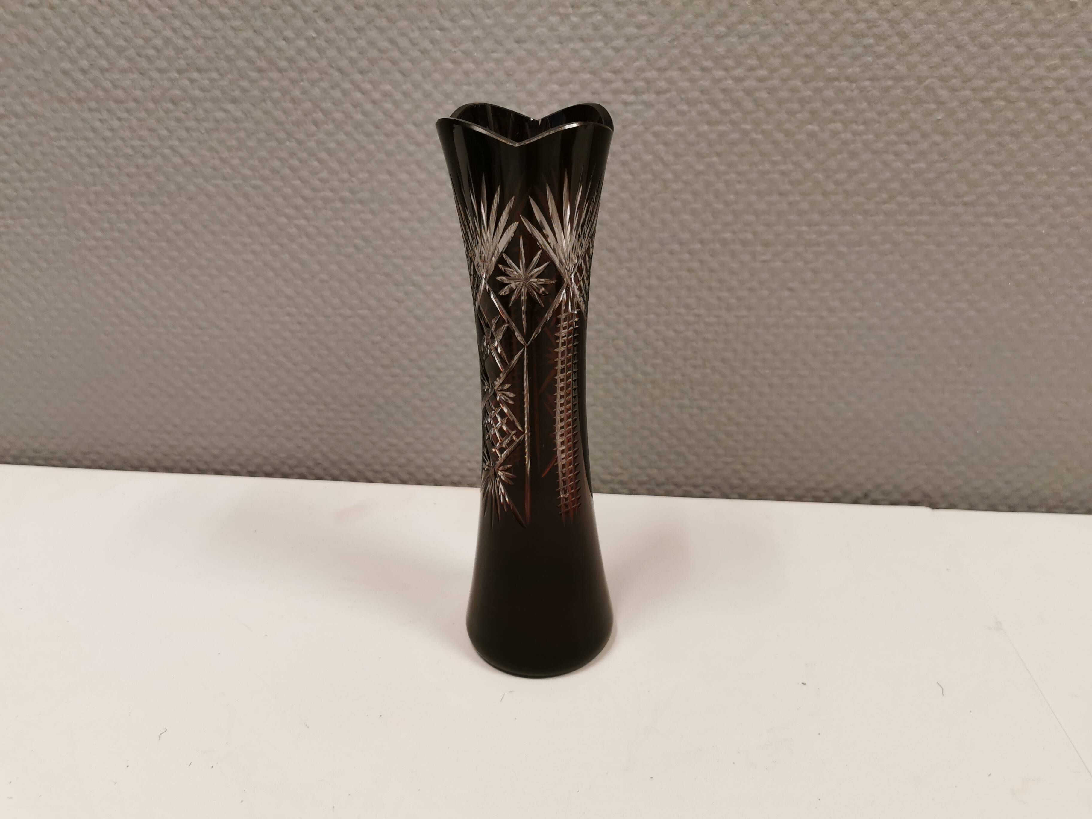 Crystal glass vase, in burgundy/reddish coloured glass with translucent details.