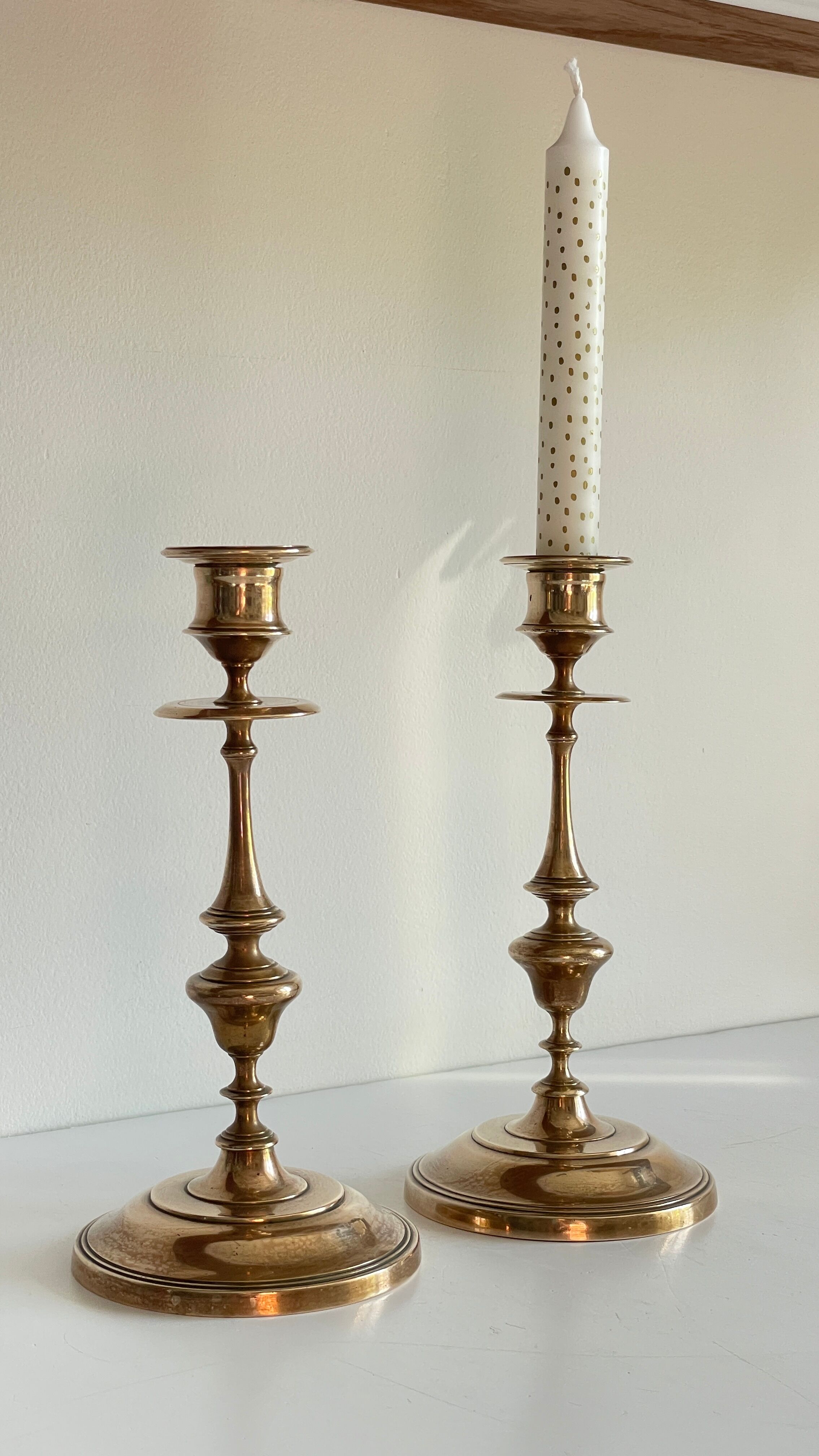 Pair of antique candle holders in solid brass