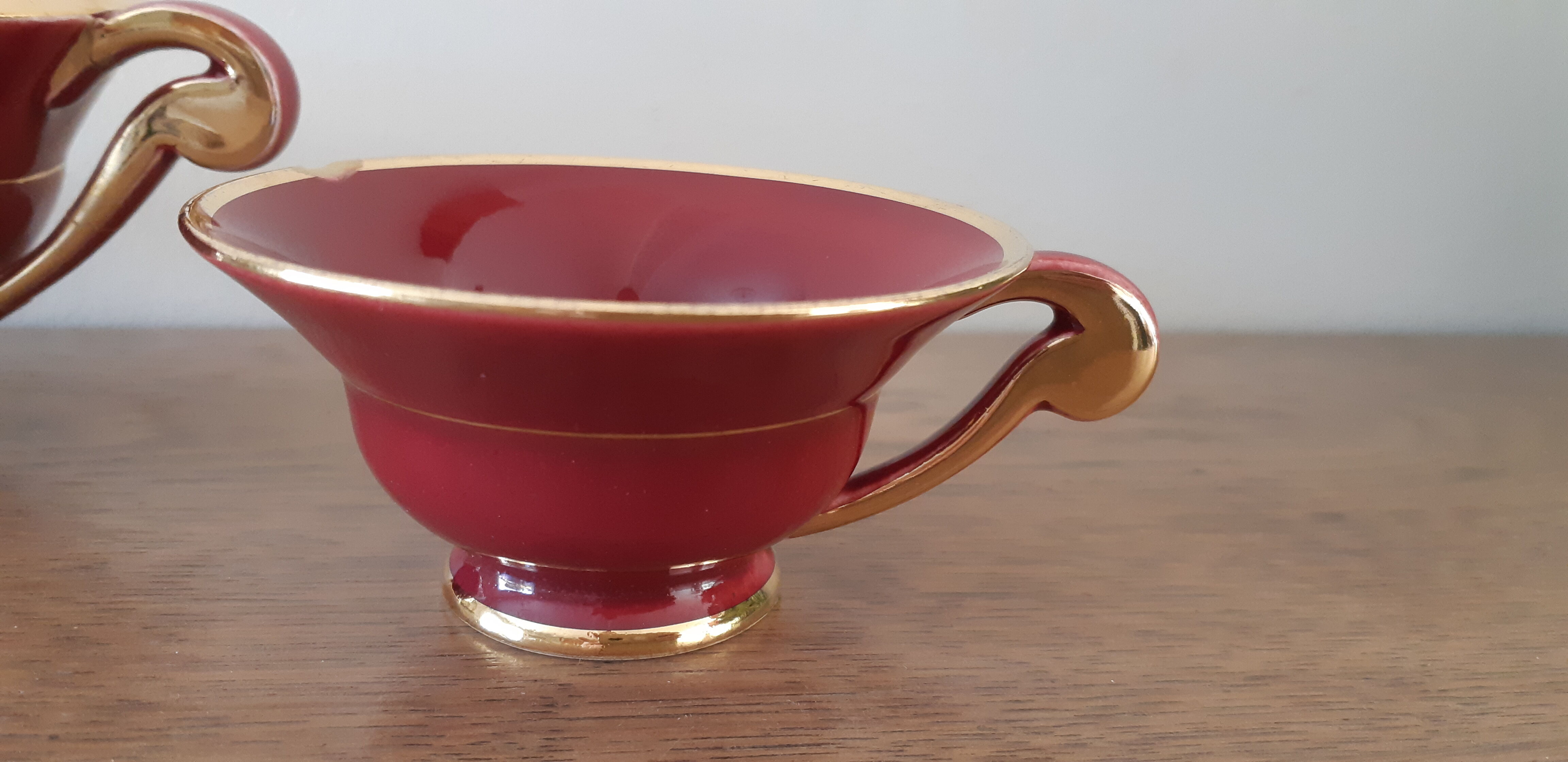Tea, coffee and sugar cups made of red and gold porcelain
